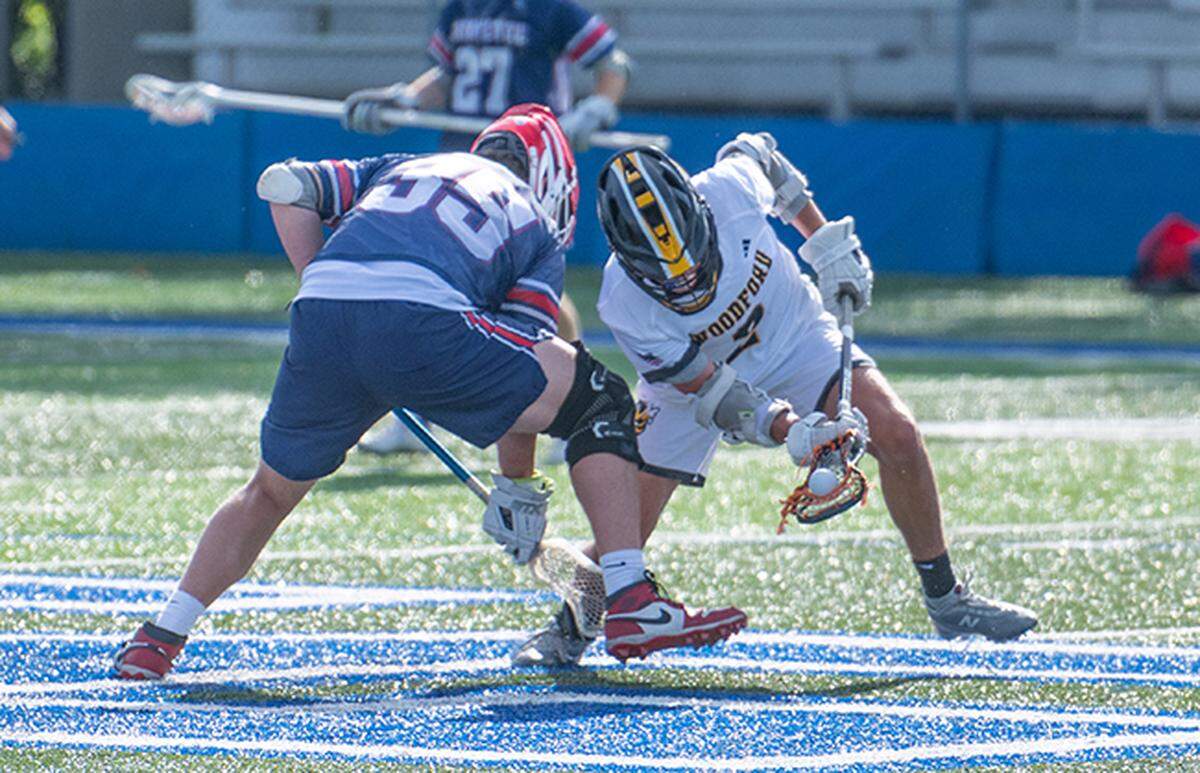 Woodford County’s Charlie Twehuse (2) wins a faceoff against Lafayette’s Gavin Noe during the Yellow Jackets’ win in the 8th Region boys lacrosse semifinals at Lexington Catholic High School on Saturday.
