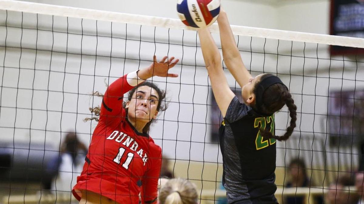 Paul Laurence Dunbar's Savannah Dudek (11) hits the ball past Bryan Station's Rachael DeMarcus (23) during the 11th Region semifinals Woodford County High School in Versailles, Ky., Wednesday, Oct. 25, 2017. Paul Laurence Dunbar beat Bryan Station 3-1.