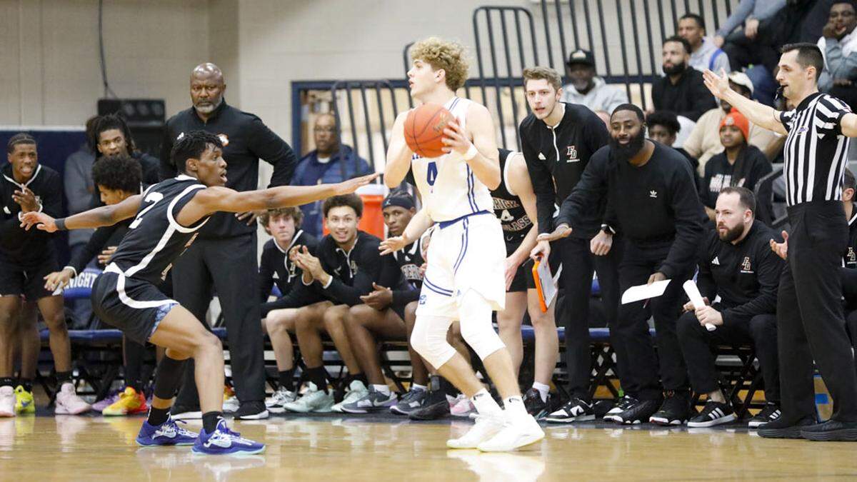 Frederick Douglass’ Jaunte Jenkins (2) guards LaRue County’s Jagger Mardis (4) in front of the Douglass bench and Broncos’ coach Murray Garvin, standing at left, during the White, Greer & Maggard Holiday Classic semifinals at Lexington Catholic on Sunday.