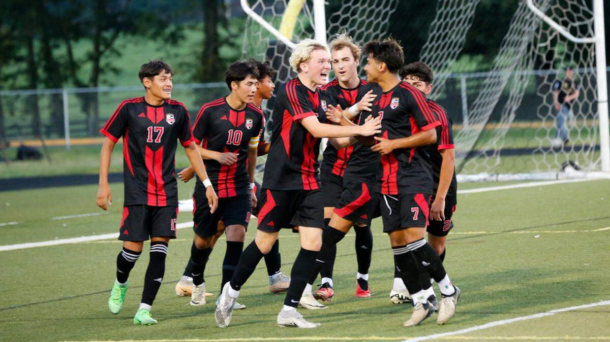Paul Laurence Dunbar’s Owen Rowe, center, celebrates with his teammates after scoring a goal against Lafayette in the Bulldogs’ 1-0 victory at Paul Laurence Dunbar High School on Tuesday.