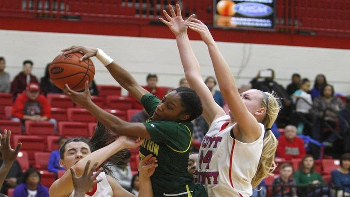 Bryan Station’s Ezzy Ighodaro pulled down a rebound against Scott County during the 42nd District tournament in Georgetown on Monday.