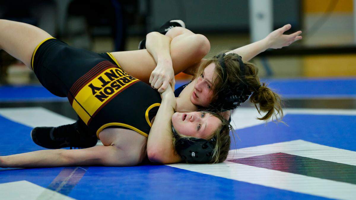 Scott County’s Ava Castleman, right, attempts to pin Harrison County’s Lily Nelson in their 107 division finals match at the Girls Region 8 Wrestling Championships at Walton-Verona High School in Walton on Saturday.