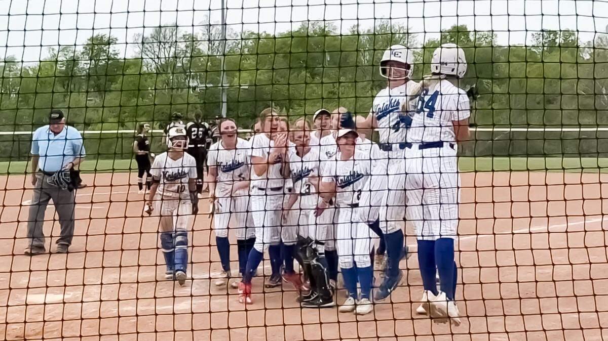 Lexington Catholic’s Abby Hammond (4) celebrates crossing the plate with teammate Ava Emmert (64) and the rest of the Knights after hitting a solo home run in the top of the sixth inning against South Warren in the Lafayette Five Star General Tournament at Great Crossing Park in Georgetown on Saturday.