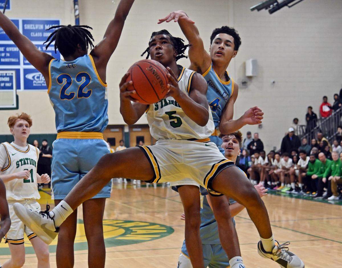 Bryan Station’s Amari Owens splits the defense of Henry Clay’s Hassan Bush (22) and AJ Dixon on the way to the basket in their 42nd District rivalry game on Friday.