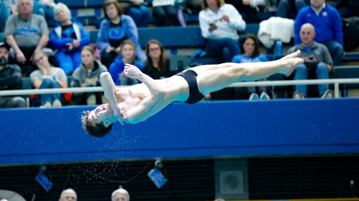 Lexington Catholic’s Graham Leslie executes a twisting dive in the finals of the KHSAA Boys State Diving Championships at the University of Kentucky’s Lancaster Aquatic Center on Saturday.