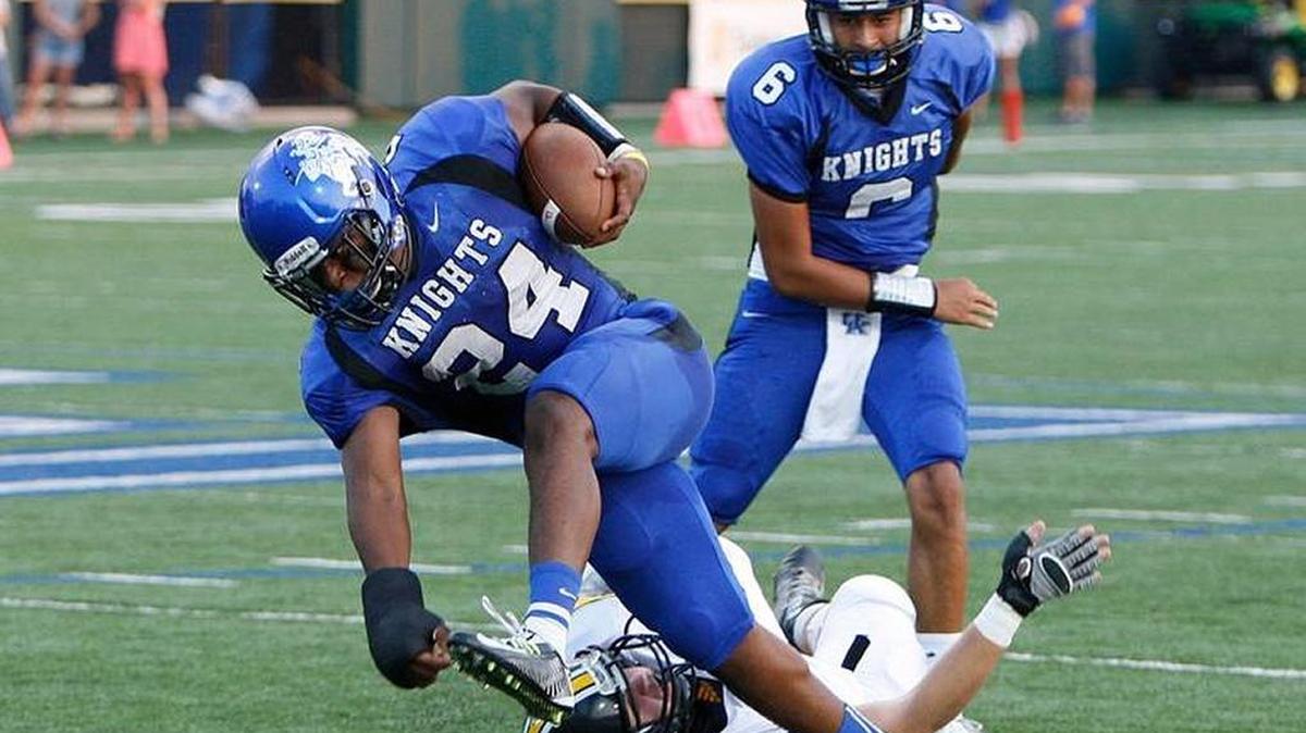 LexCath’s Jaylen Jones broke a tackle while running against Johnson Central at Lexington Catholic football stadium on Sept. 4.