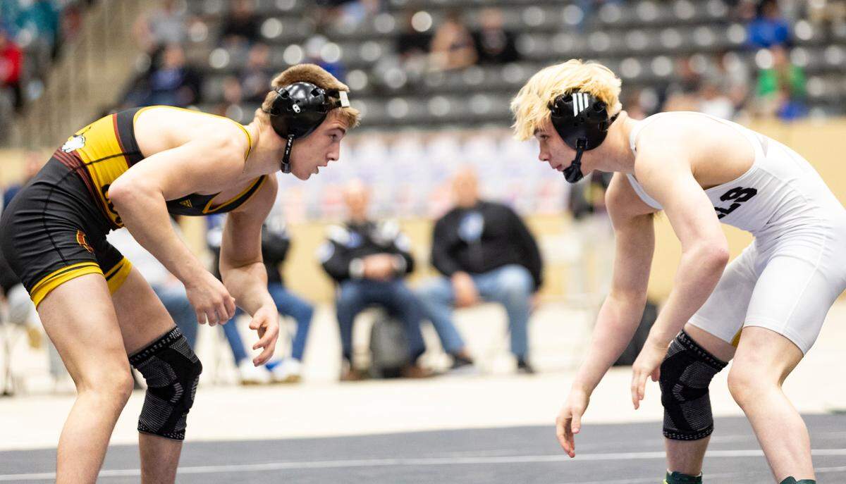 Harrison County’s George Dennis, left, and Boyle County’s Kaygen Roberts battled for three rounds and three overtime periods before Dennis scored an ultimate tie breaker point for a 3-2 win in the 144-pound state finals Saturday.
