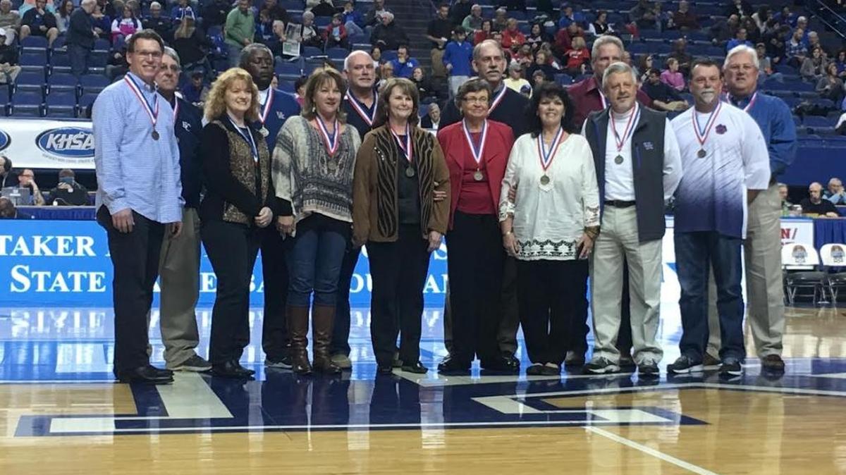 On the 40-year anniversary of their 1976 Sweet Sixteen championship, members of the Edmonson County Wildcats were recognized on the floor at Rupp Arena during the 2016 Boys’ State Tournament. From left to right: Point guard Kevin Clemmons; team manager Larry Starnes; cheerleader Becky Alford Brannon; shooting guard Chester Bethel; cheerleader Lisa Meredith Price; Tim Ashley; cheerleader Stephanie Stewart Gipson; Mary Frances Davenport, widow of Coach Bo Davenport; power forward Mark Hennion; cheerleader Teri Vincent Webb; Ricky Houchin; center Phil Rich; Jimmy Cole; small forward Aaron Goad.