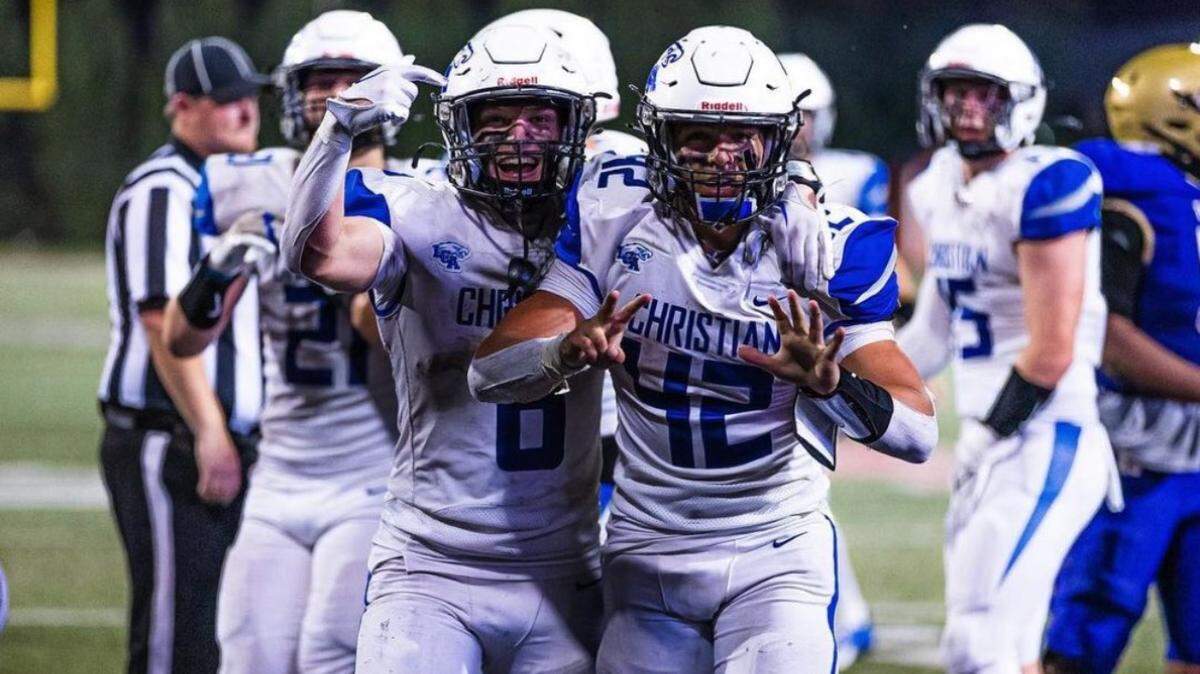 Lexington Christian’s Brady Hensley, right, celebrates with teammate Parker Chaney after scoring his seventh touchdown of the game to help the Eagles take a 56-52 lead over Bowling Green with 27 seconds left in the game.