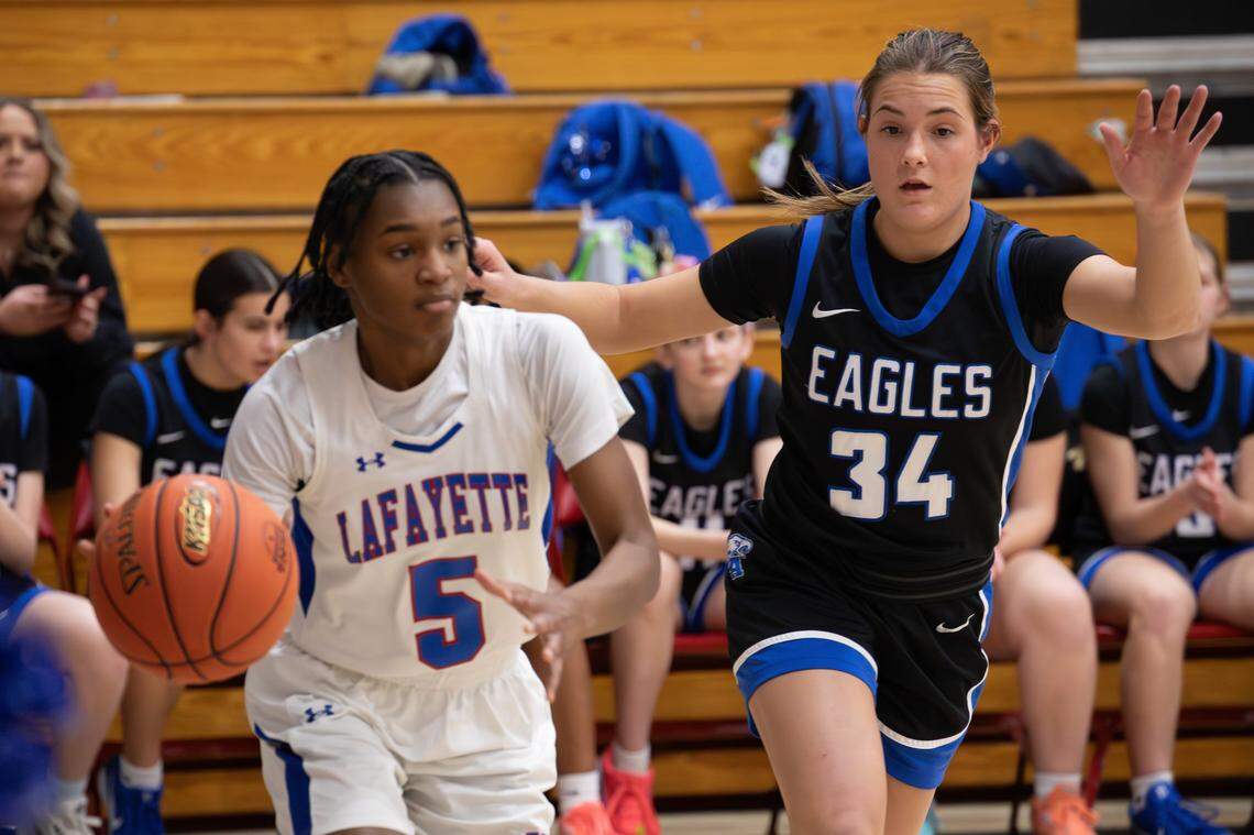 Lexington Christian’s Jentry Bertram (34) defends Lafayette’s E'Maria Owens during a girls' 43rd District Tournament semifinal game Wednesday.