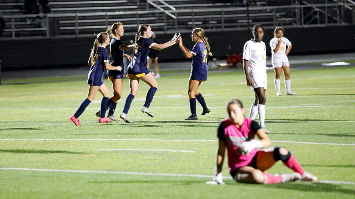 Sayre’s Katherine Monohan, third from left, celebrates with her teammates after scoring the go-ahead goal in the Spartans’ 2-1 win against Bryan Station during the 42nd District girls soccer tournament at Frederick Douglass High School on Monday.