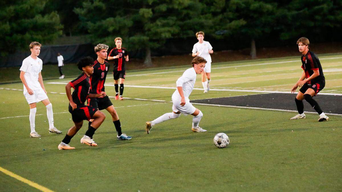 Henry Clay’s Marco Messerli, center, maneuvers through Paul Laurence Dunbar’s defense near midfield during the Blue Devils’ 4-1 win at Paul Laurence Dunbar High School on Tuesday.