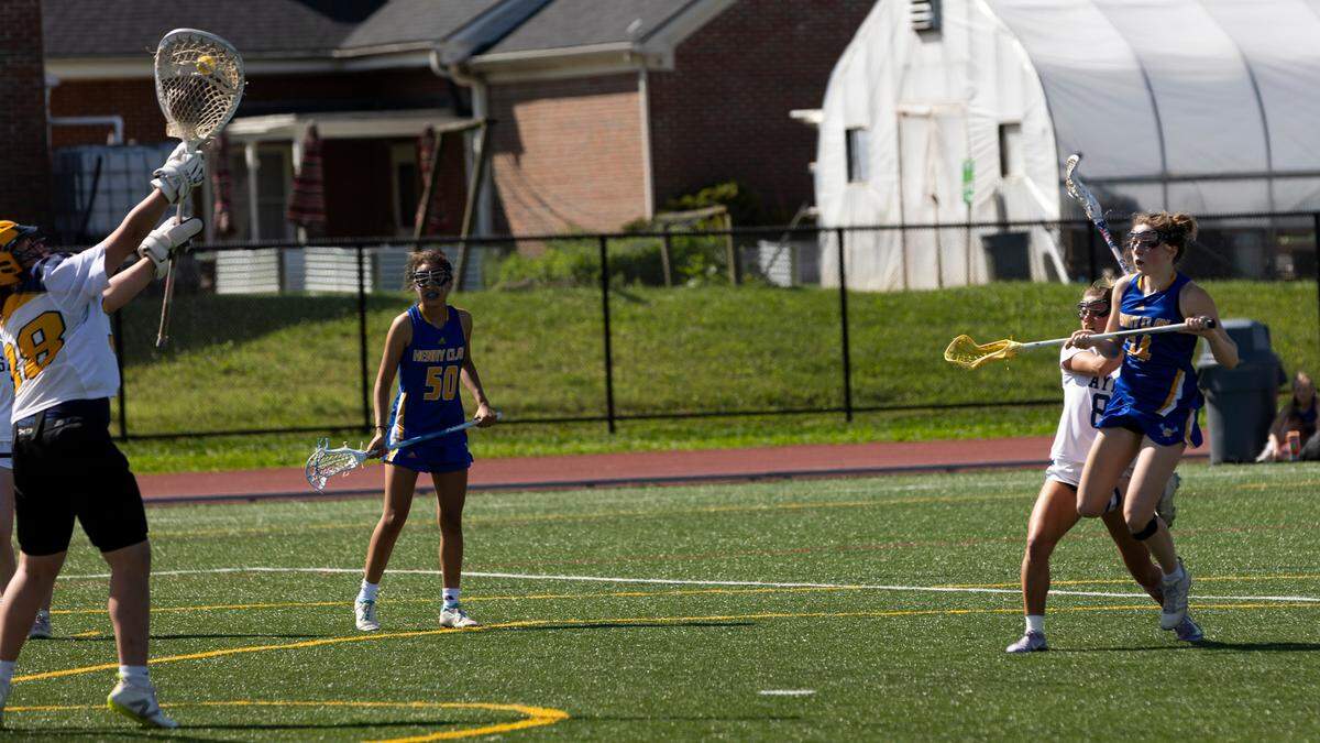 Sayre goalie Emeline Offut (18) makes a save against Henry Clay’s Caroline Elkinson (14) during the Spartans’ 15-8 win at Transylvania University’s Pat Deacon Stadium in the state tournament quarterfinals on Saturday.