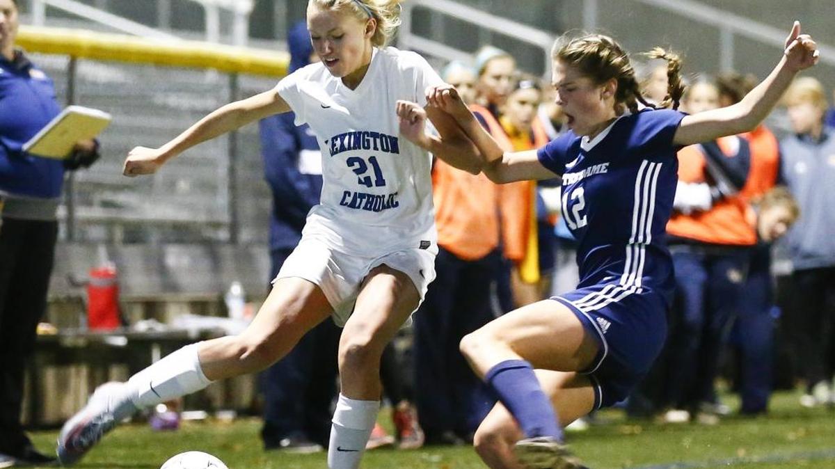 Lexington Catholic’s Emma James Bryant (21) battled for the ball with Notre Dame’s Maya Decker (12) during their semi-state game at Lexington Catholic on Tuesday. Notre Dame beat Lexington Catholic 4-1.