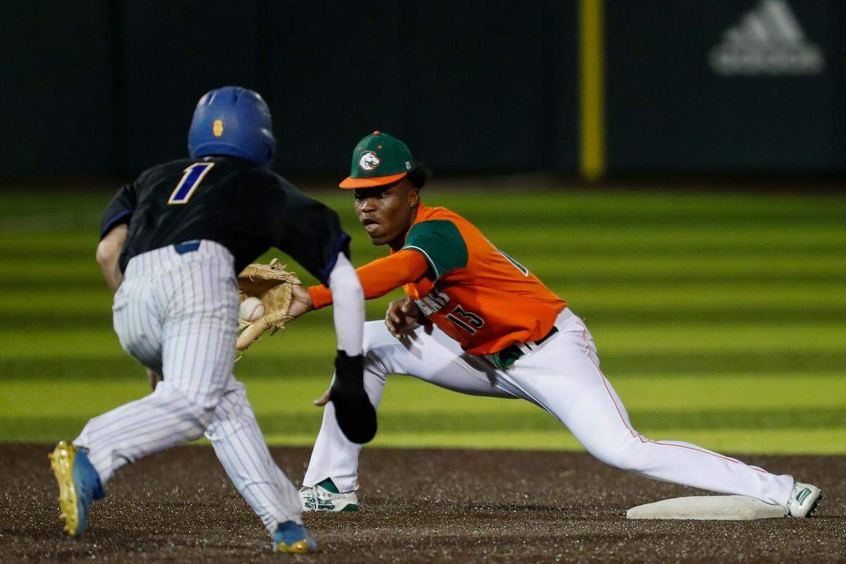 Frederick Douglass’s Ty Bryant, right, tries to tag out Henry Clay’s Konlin Brown (1) at second base during the teams’ game at EKU on April 13.