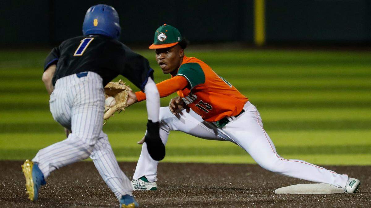 Frederick Douglass’ Ty Bryant, right, tries to tag out Henry Clay’s Konlin Brown at second base during a game at Eastern Kentucky University’s Earle Combs Stadium on April 13.