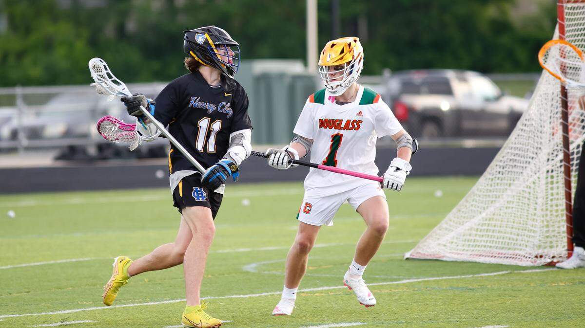 Henry Clay attacker Jonah Brooking (11) looks for an opening while being defended by Landon Davis of Frederick Douglass during the Commonwealth Lacrosse League Region 2 championship game at The Farm on Wednesday.