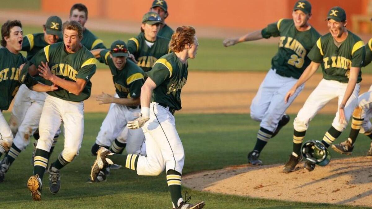St. Xavier's Cam Scheler, 10, celebrated with teammates after his two-run double put his team up for good.