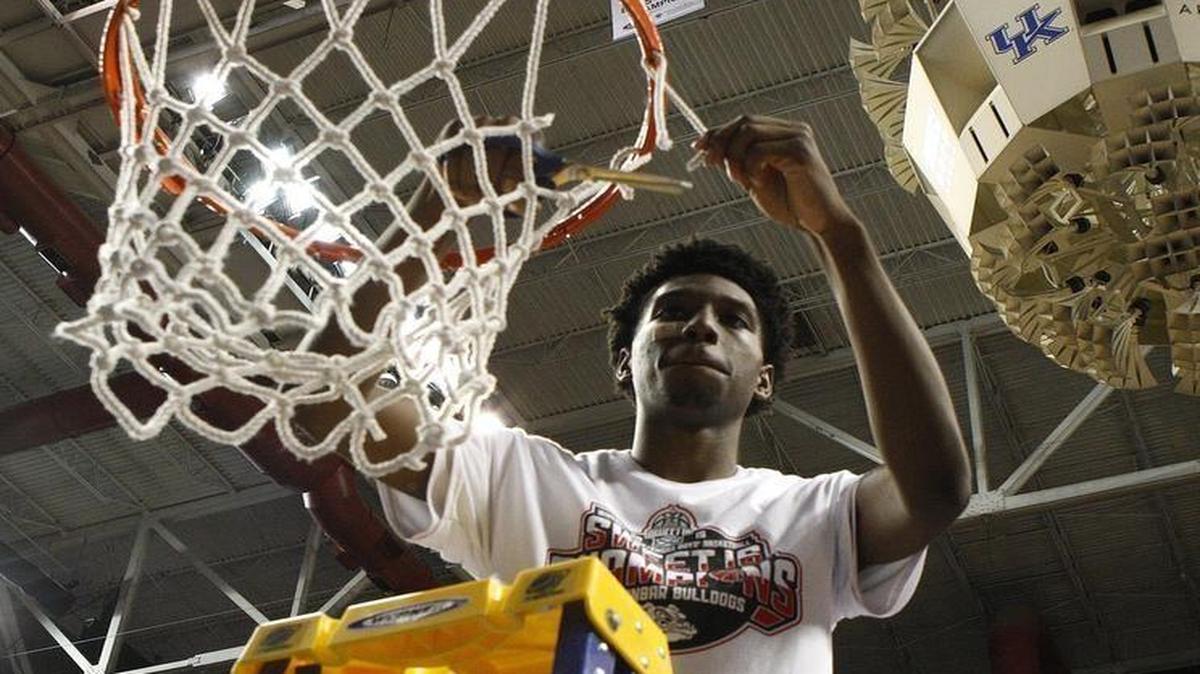 Paul Dunbar’s Taveion Hollingsowrth, the Sweet Sixteen MVP, cut the net after his team’s win over Doss in the championship game in Rupp Arena in Lexington on Sunday, March 20, 2016.