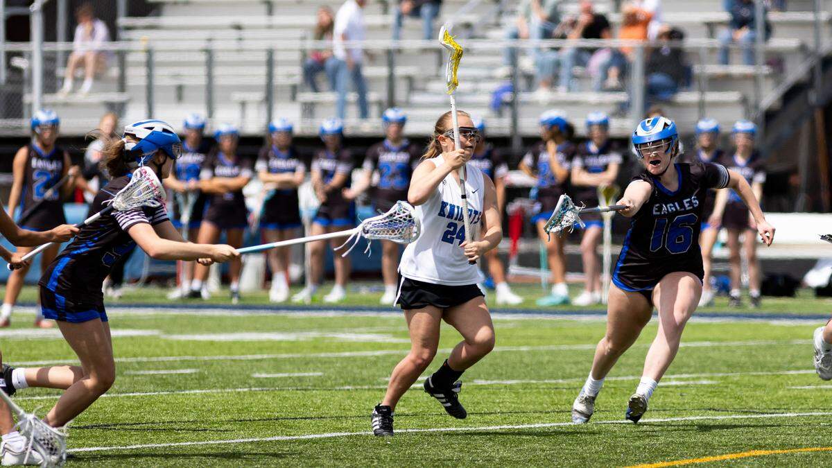 Lexington Catholic’s Christy Cervoni (24) goes for a shot between Lexington Christian’s Madilyn Wilder, left, and Emily Ison.