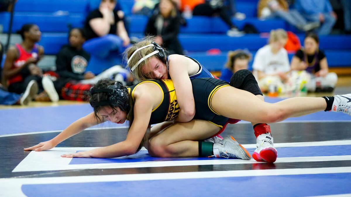 Scott County’s Samantha Oliver covers Harrison County’s Sophia Moore during their 114 division finals match at the Girls Region 8 Wrestling Championships at Walton-Verona High School in Walton on Saturday.