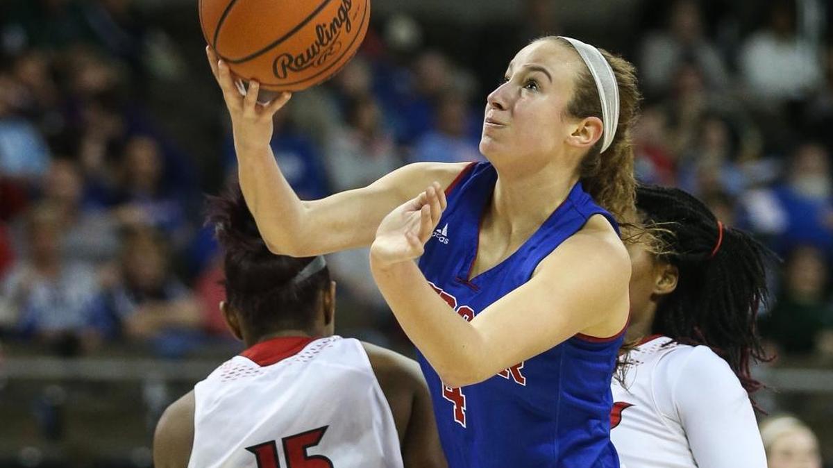 Seygan Robins put up an off-balance shot as she slid between two Holmes defenders during Mercer County’s 59-55 win in the girls’ state tournament in March.