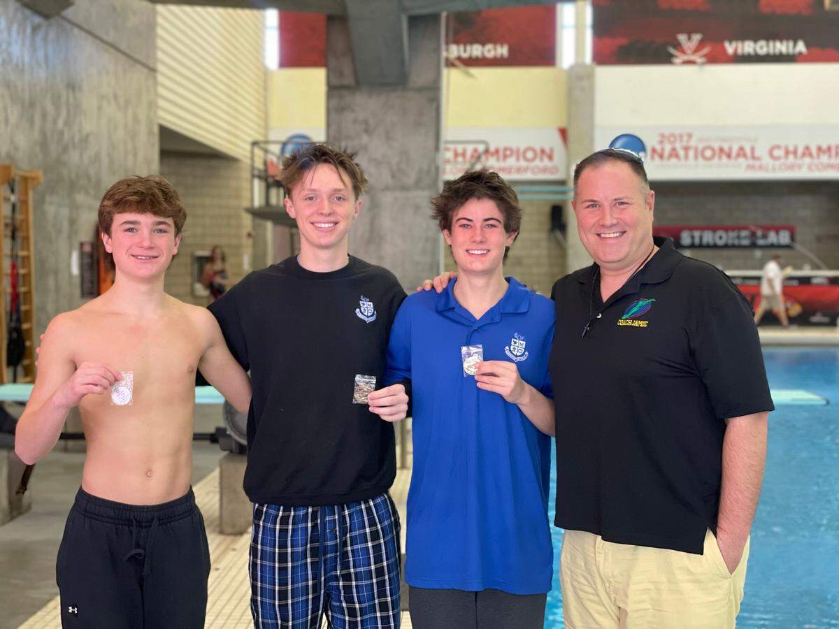 Lexington Catholic diving coach Jamie Palumbo poses with his boys team, from left, Graham Leslie, Jett Vanderhorst and Miles Buchart after the Region 8 Diving Championships at the University of Louisville on Monday.