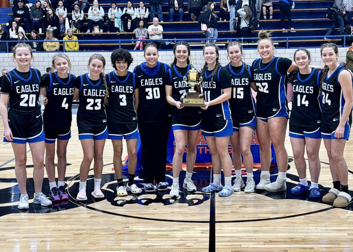 Lexington Christian’s girls basketball team celebrates with its 11th Region All “A” Classic trophy after defeating Berea 41-38 at Frankfort High School’s F.D. Wilkinson Gymnasium on Saturday.