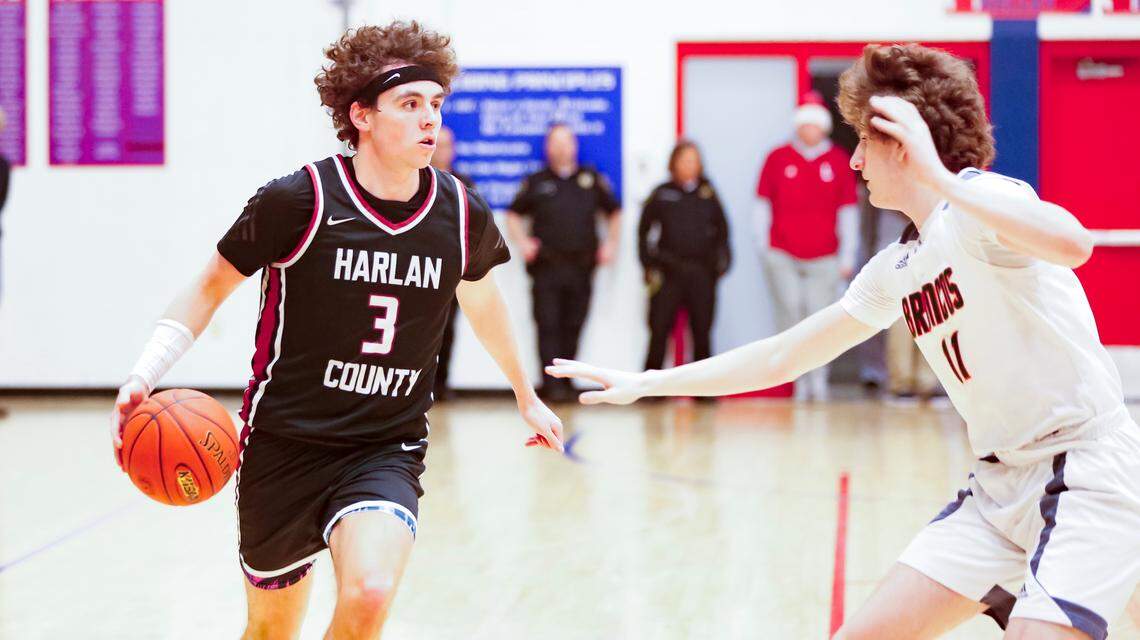 Harlan County’s Maddox Huff advances the ball while guarded by Frederick Douglass’ James Clare during the Broncos’ 70-58 win at Lafayette High School’s Jock Sutherland Classic on Feb. 8.