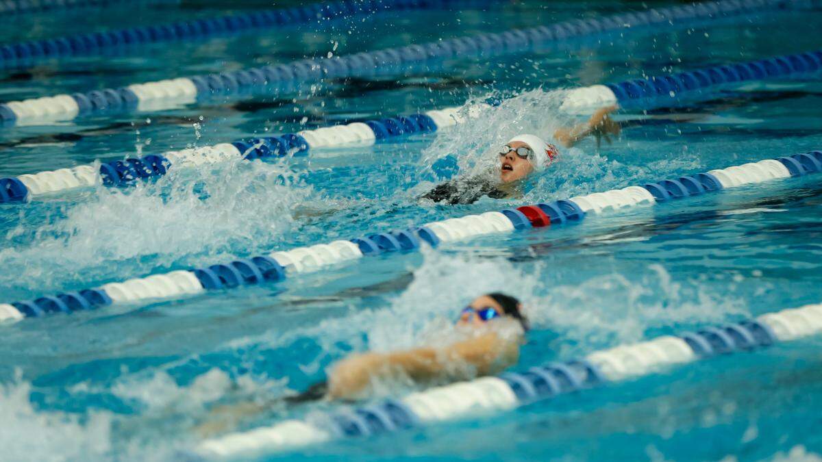 Paul Laurence Dunbar’s Kennedy Brooks, top, raced to a region record in the 100-yard backstroke at the Region 8 Swimming and Diving Championships at Stivers Aquatic Center in Barbourville on Saturday.