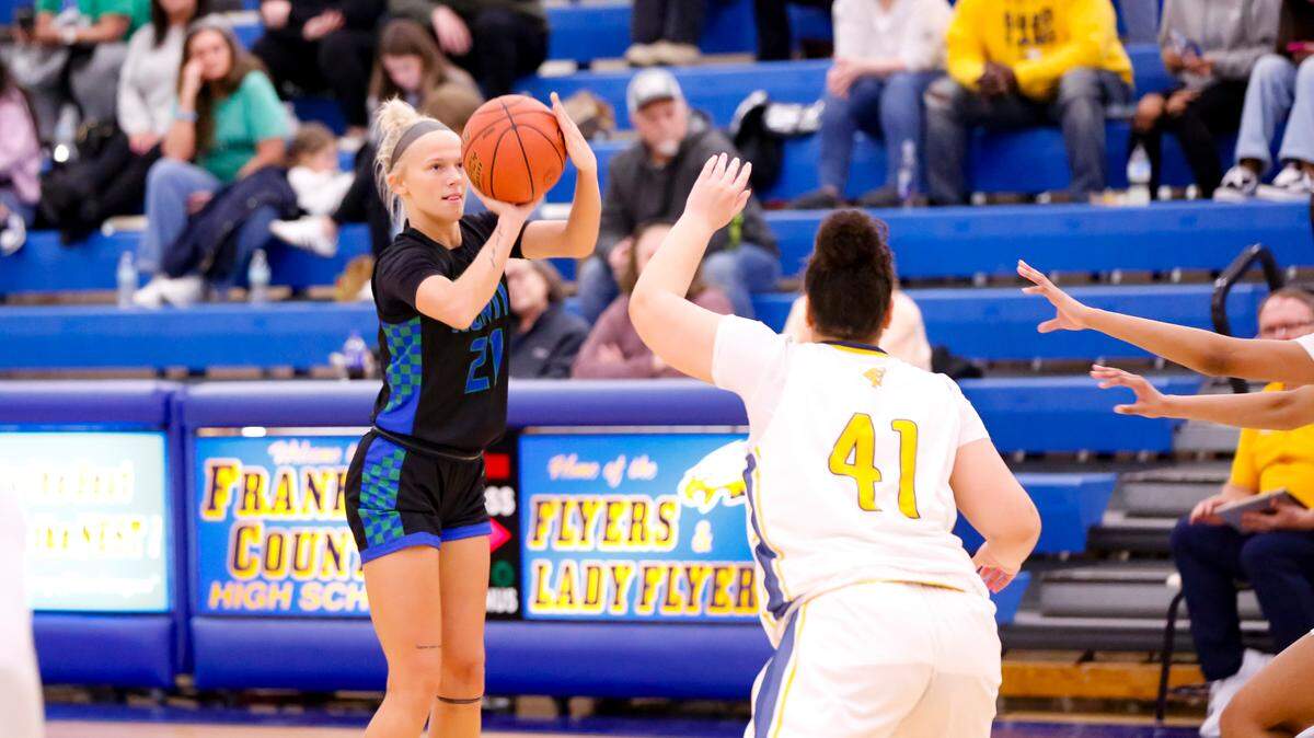 North Laurel’s Brooke Nichelson (21) lines up a 3-pointer as Franklin County’s Maleric Walton (41) rushes to defend it during the Jaguars’ 63-57 win at Franklin County High School in Frankfort on Feb. 10.