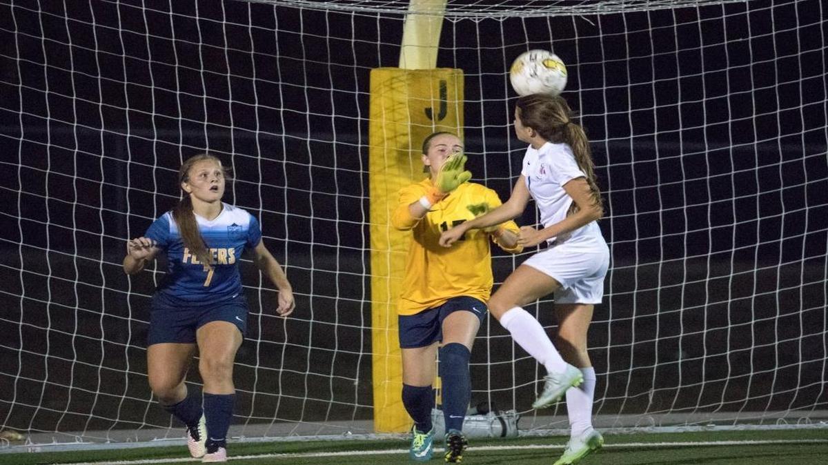 Madison Central's Kelsey Powell (1) headed the ball in to the goal over Franklin County's Jenna Ruebens (17) goalie as Madison Central won 1-0 over Franklin County in the first round of the 11th Region Tournament held at Woodford County's Falling Spring Complex on Monday Oct. 17, 2016, in Versailles.