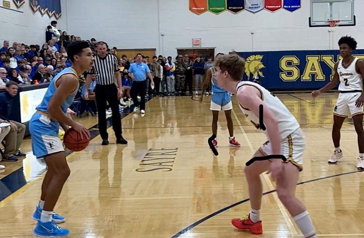 Henry Clay’s AJ Dixon spots up to shoot facing Sayre’s Ian Reesor during the first half of the Blue Devils’ 64-60 win over the Spartans at Sayre School on Tuesday. Dixon was one of four Blue Devils in double figures with 12 points.