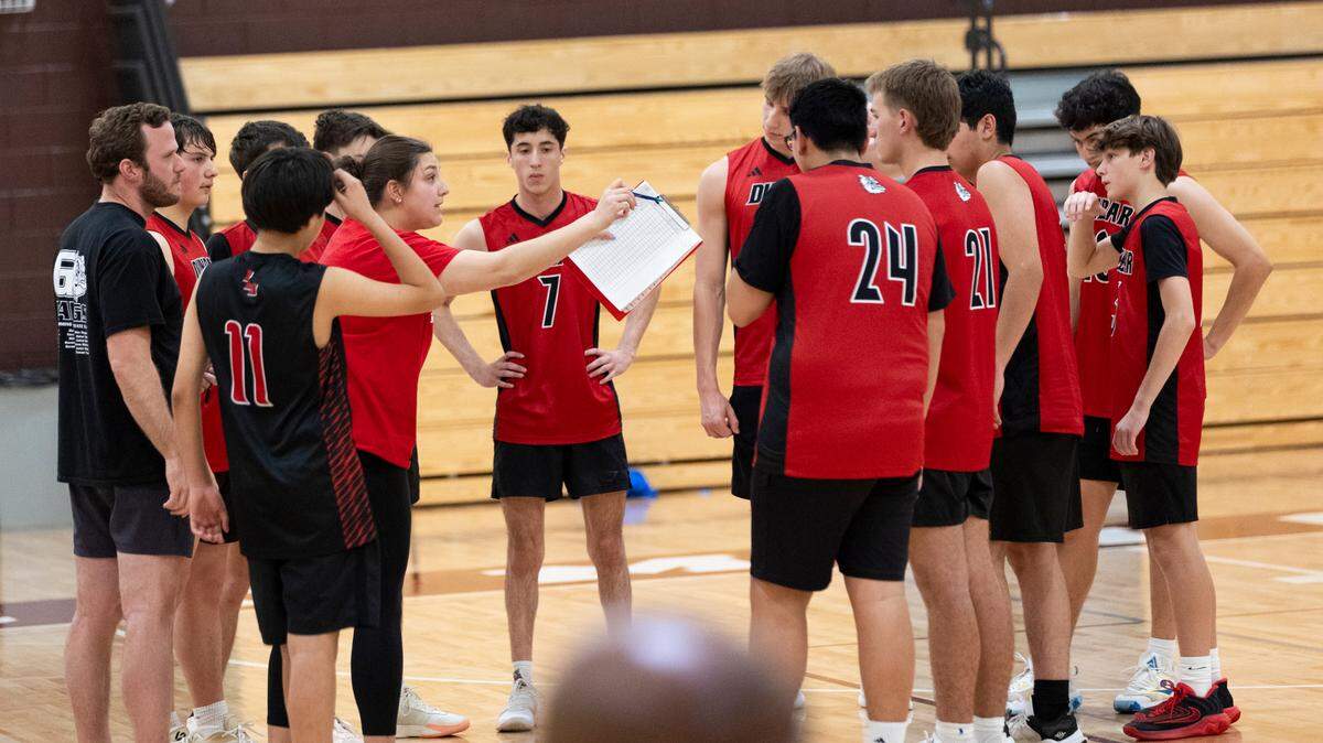 Paul Laurence Dunbar head coach Abigail Shafer, holding a clipboard, instructs her team during a timeout of their volleyball game at Tates Creek High School on Thursday.