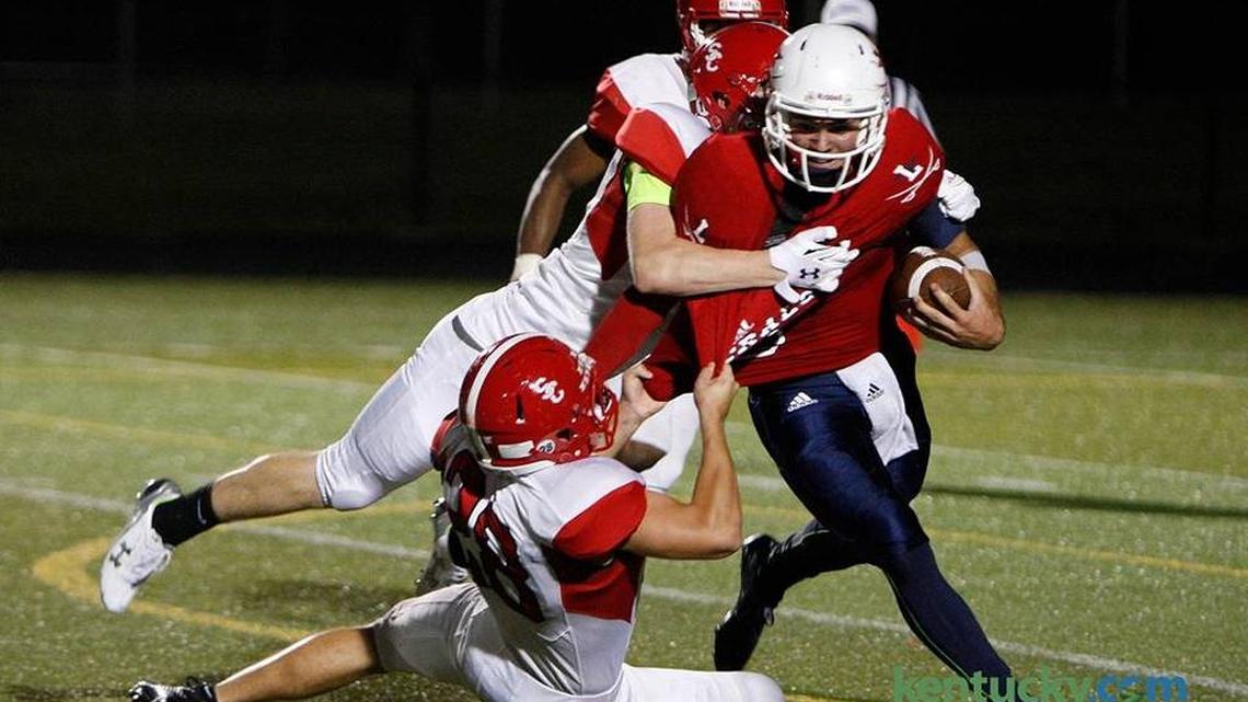 Lafayette quarterback Walker Wood is sacked after faking a punt attempt for the turnover against Scott Co. at Ishmael Stadium in Lexington, Ky., Friday, September 18, 2015.