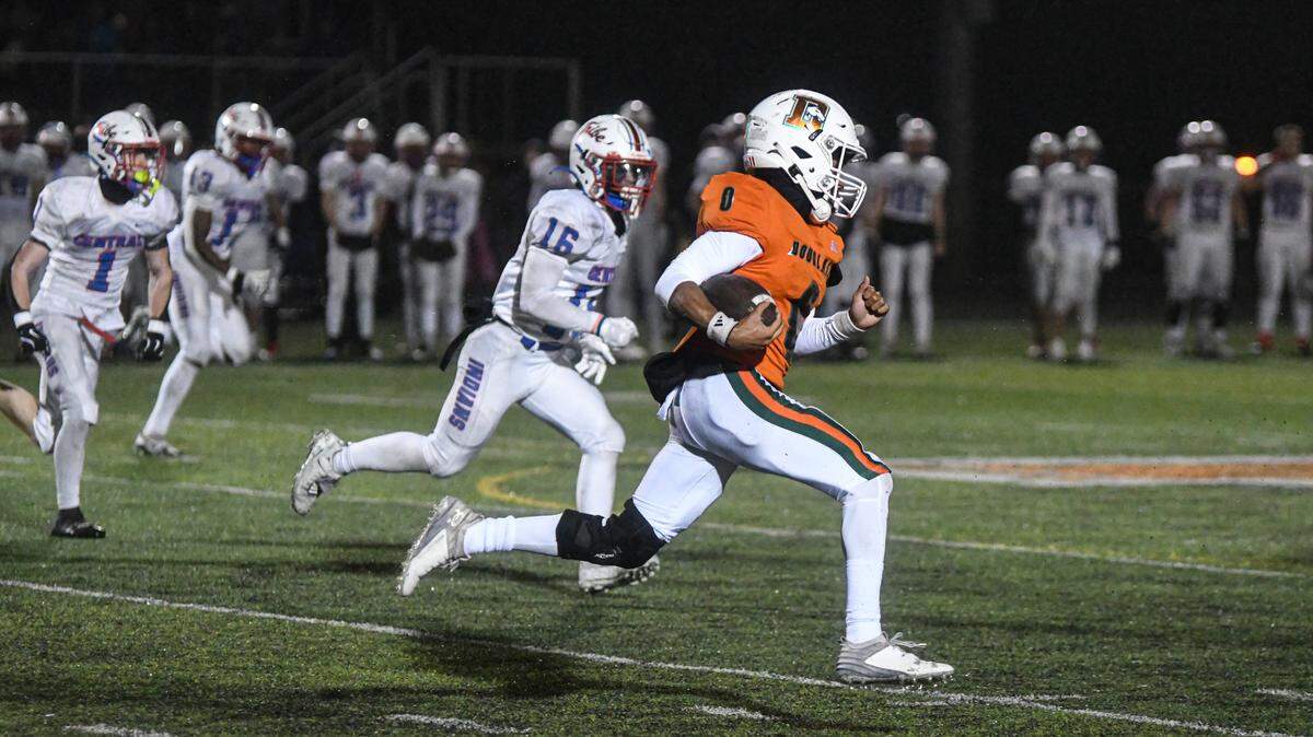 Frederick Douglass kickoff returner Derion Talbert (0) angles toward the sideline with Madison Central’s Aiden Parker (16) in pursuit. Talbert broke a 77-yard touchdown on the play in the Broncos’ 36-6 region championship win at The Farm on Friday.