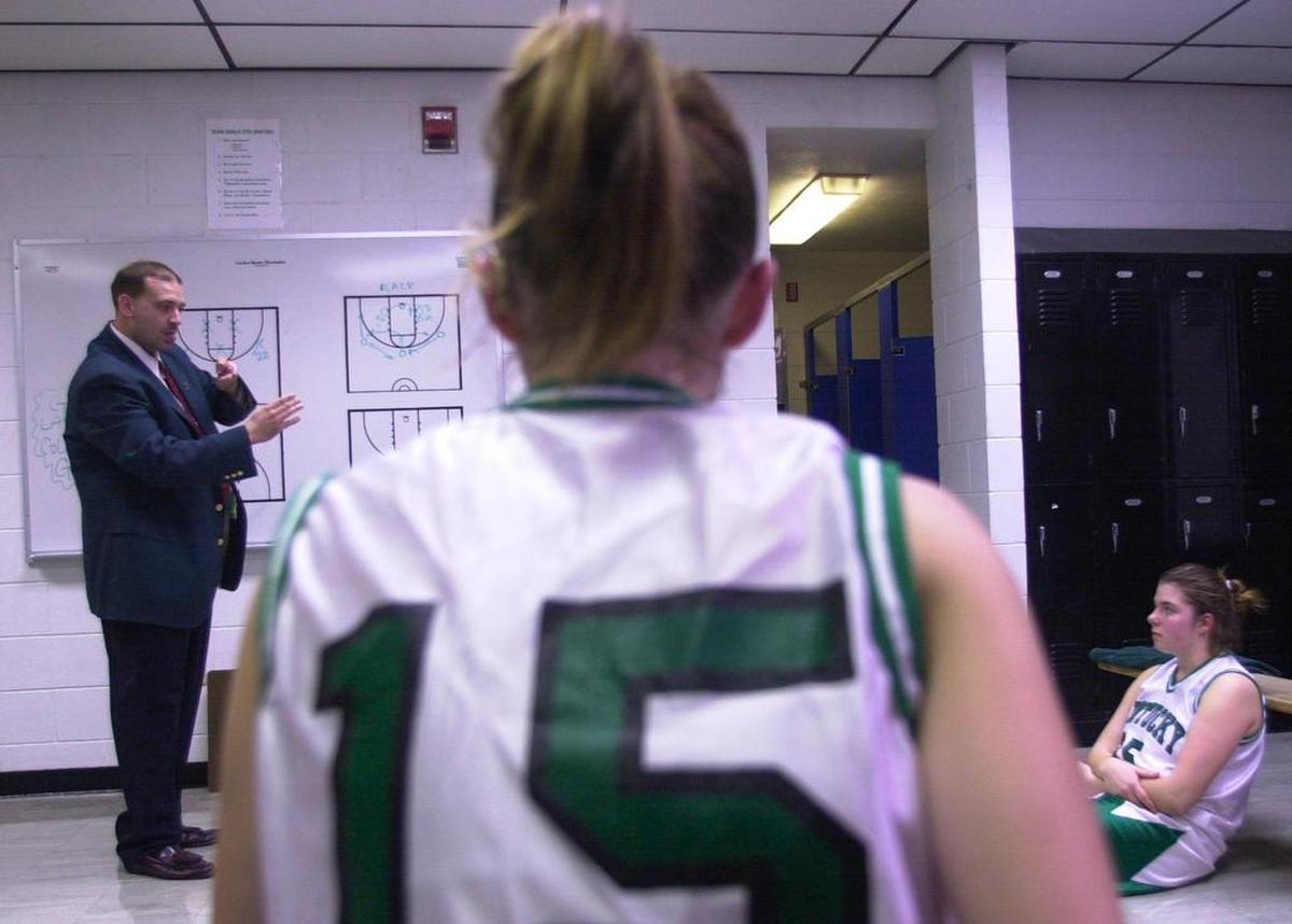 File photo: Byron Wilson, the head coach of the girls’ basketball team at the Kentucky School for the Deaf, uses sign language to communicate with his players, some of whom can hear with the aid of a listening device, in Danville, Ky. on Dec. 14, 2000.