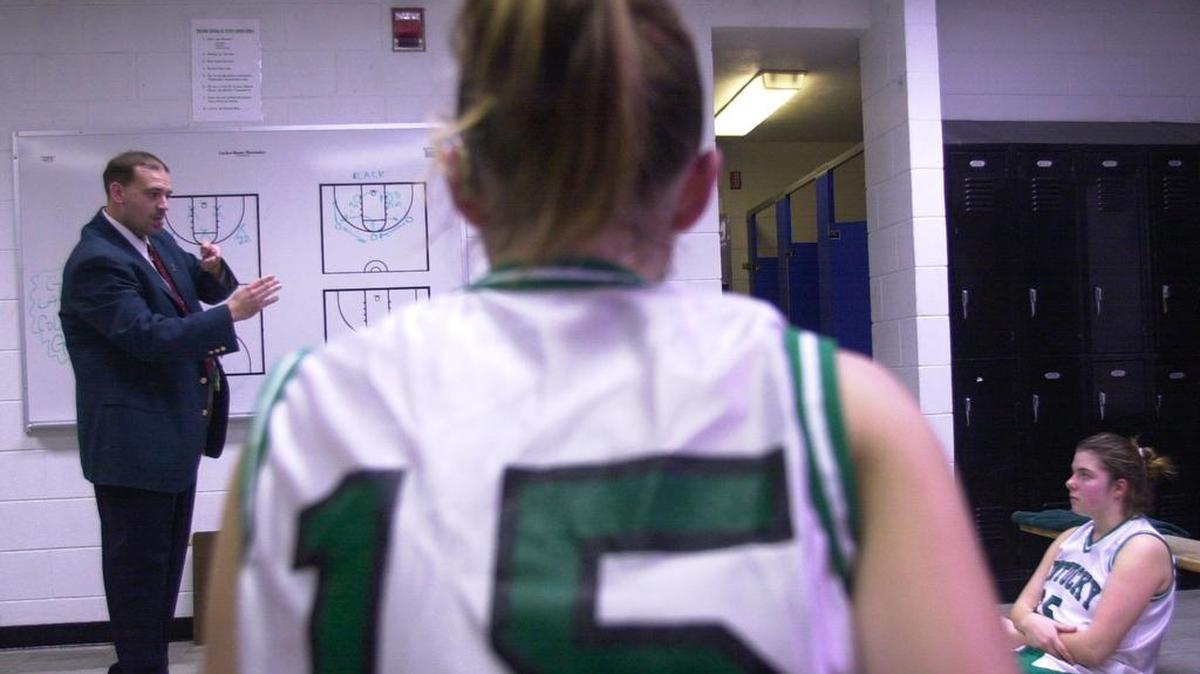 File photo: Byron Wilson, the head coach of the girls’ basketball team at the Kentucky School for the Deaf, uses sign language to communicate with his players, some of whom can hear with the aid of a listening device, in Danville, Ky. on Dec. 14, 2000.