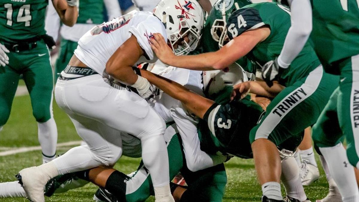 Lafayette's Ean Shaw (23) strips the ball from Trinity's Roderick Thomas (3) Saturday, December 3, 2016, during the Class 6A Russell Athletic/KHSAA Commonwealth Gridiron Bowl at Houchens Industries-L. T. Smith Stadium in Bowling Green, Ky. (AP Photo/Daily News, Bac Totrong)