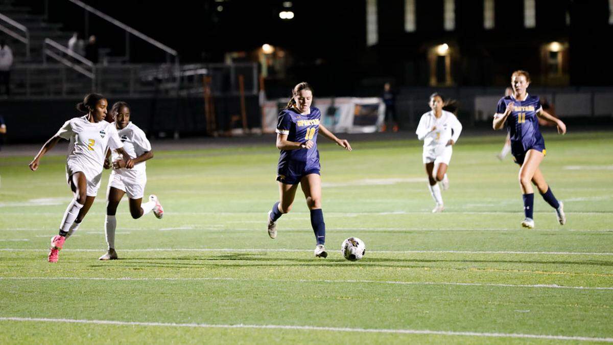 Sayre’s Katherine Monohan (10) dribbled through the Bryan Station defense with the Defenders’ Heavan Dobson (2) tracking her during the Spartans’ 2-1 win over Bryan Station during the 42nd District girls soccer tournament at Frederick Douglass High School on Monday.