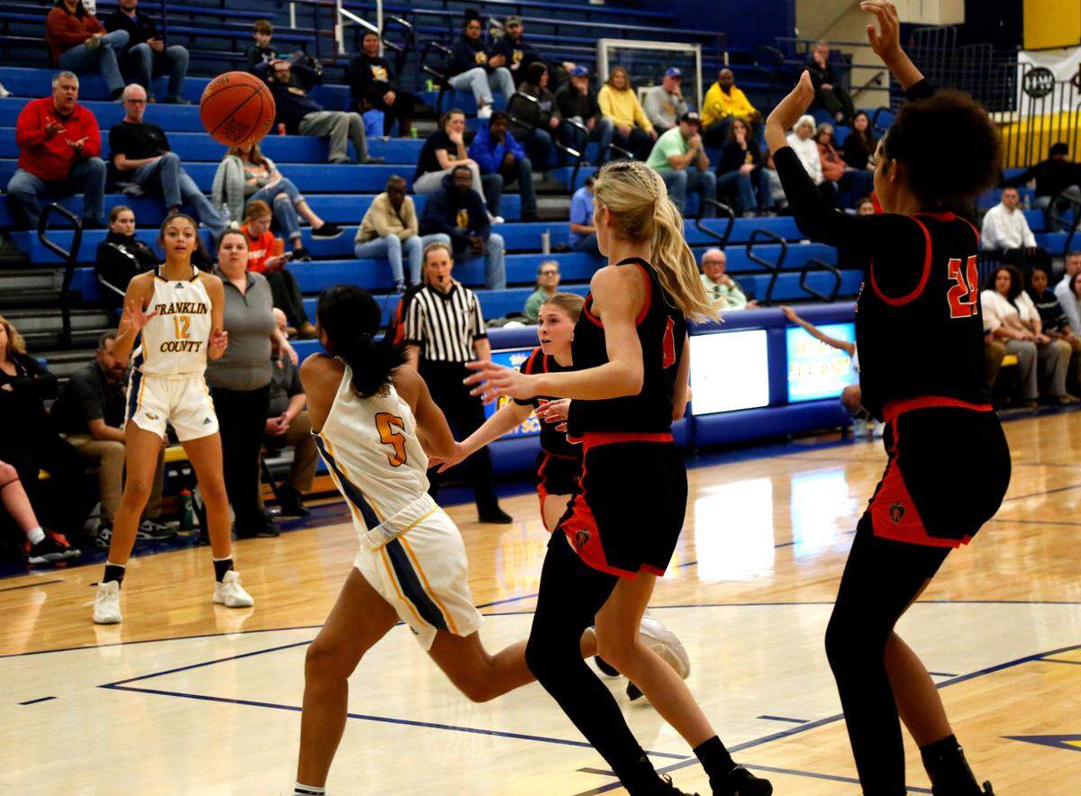 Franklin County’s Leia Hogan (5) passes the ball out to teammate Rachel Shropshire (12) at the 3-point line during the Flyers’ 66-46 win over Ryle in Frankfort on Thursday.