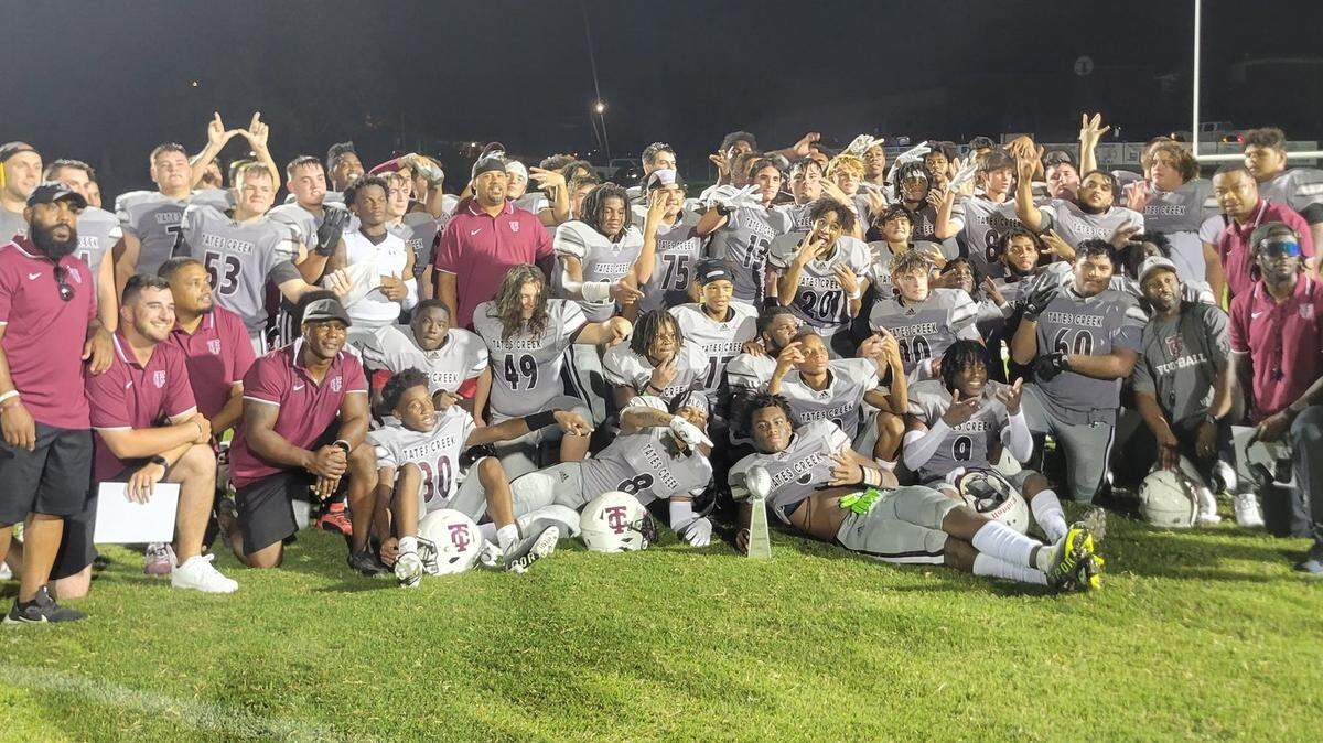 Tates Creek celebrated on the field with its Fort Harrod Bowl trophy after the Commodores’ 28-21 win over Mercer County on Saturday in Harrodsburg.