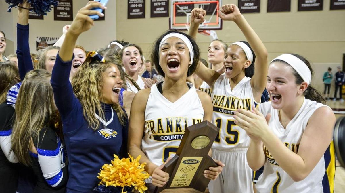 Franklin County s Princess Stewart (5), center, celebrated with Franklin County cheerleader Chynna Jackson, left, and Kindall Talley (1), right, after beating Henry Clay 58-56 in the 11th Region finals last year at EKU