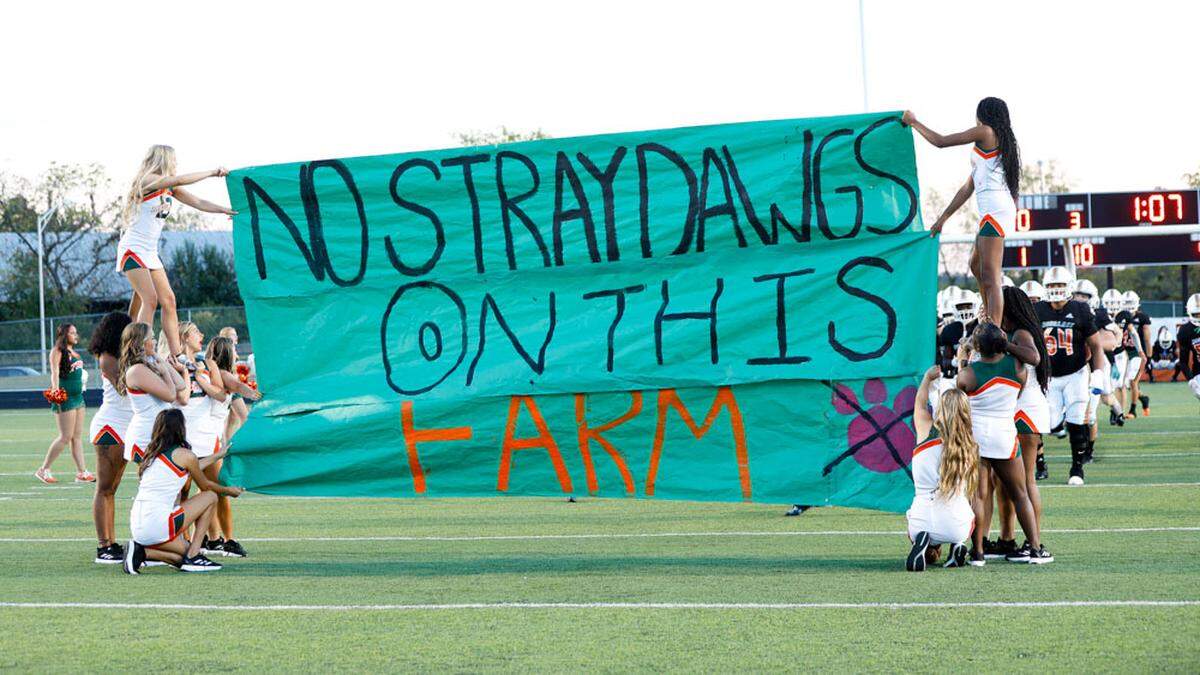 Frederick Douglass prepares to break through the cheer squad’s pep banner at the start of the Broncos’ home game against Corbin at The Farm on Friday.