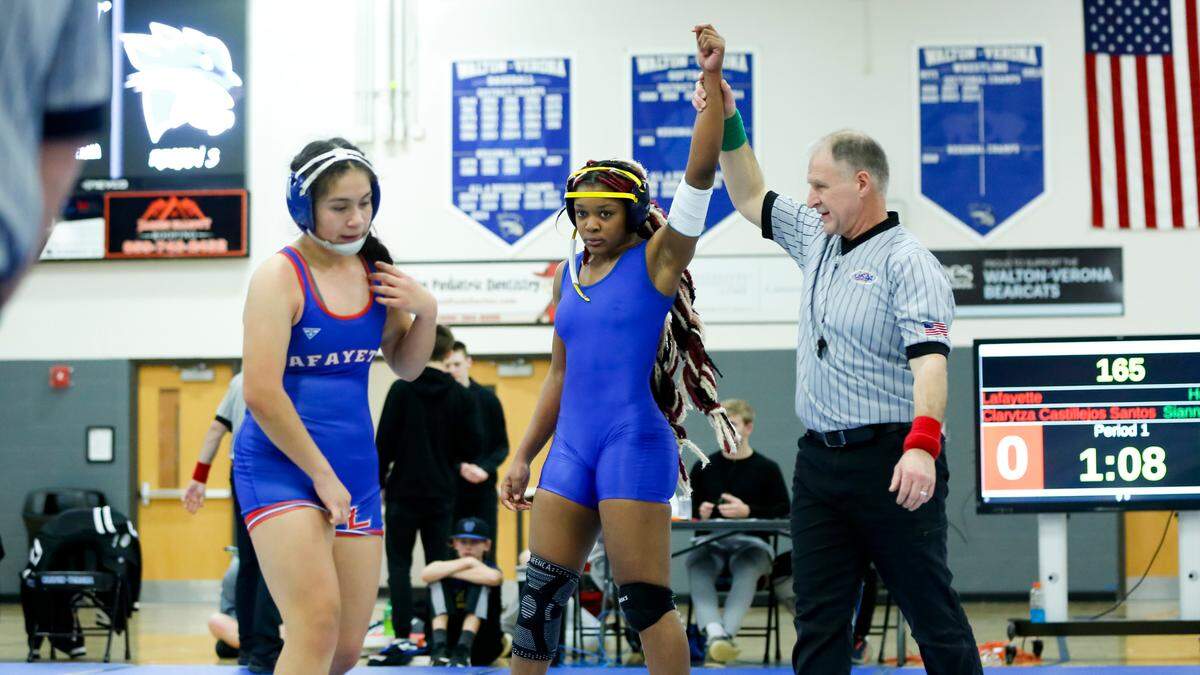 Henry Clay’s Sianni Appolon, center, defeats Lafayette’s Clarytza Castillejos Santos in the quickest match of the day, getting the fall in 52 seconds in the 165 division of the Girls Region 8 Wrestling Championships at Walton-Verona High School in Walton on Saturday.