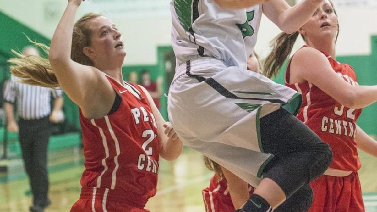 Jenkins High School basketball star Whitney Creech drives past three Central Perry players to score two of her 61 points Monday, December 14, 2015 in Jenkins, Ky.
