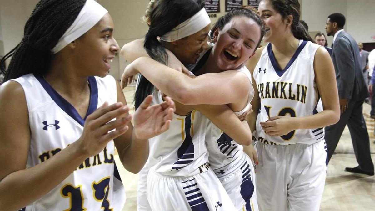 Franklin County's Princess Stewart and Kindall Talley hugged after defeating Bryan Station to win the girls’ 11th Region championship at McBrayer Arena in Richmond.