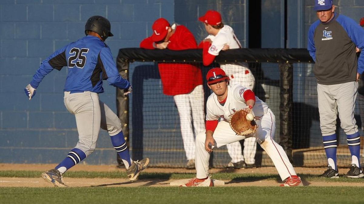 Lafayette first baseman Eddie Satisky checks LexCath's C. J. Bush leading off at Lafayette's baseball stadium in Lexington, Ky., Tuesday, April 5, 2016.