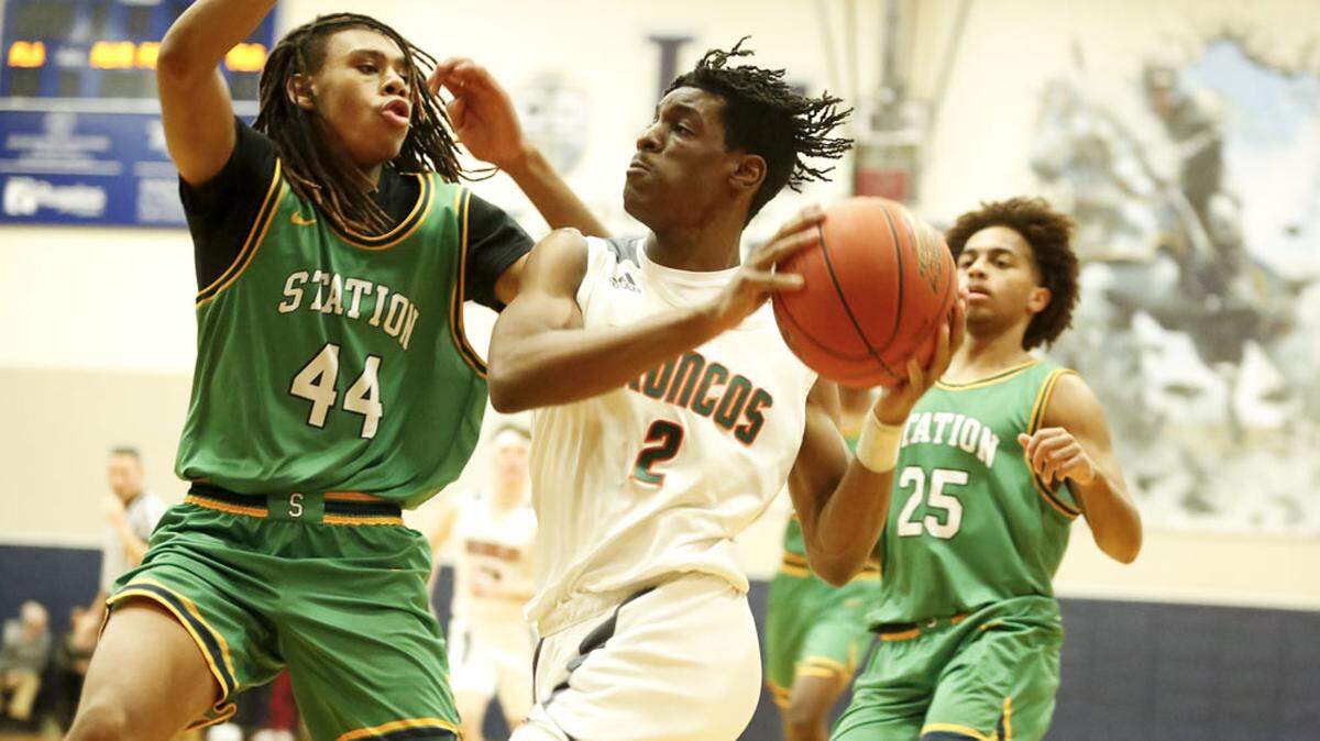 Frederick Douglass forward Jaunte Jenkins (2) drives into the lane against Bryan Station’s Antowone Burton as the Defenders’ Rashaad Faulkner (25) trails the play during the White, Greer & Maggard Holiday Classic championship game at Lexington Catholic on Monday.