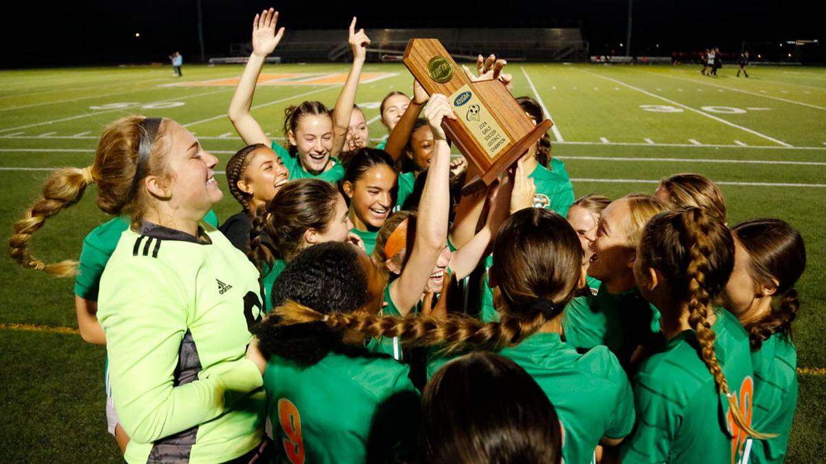Frederick Douglass senior forward Maddi Merryweather holds aloft the girls 42nd District Tournament championship trophy as she and her teammates celebrate their 1-0 win over Henry Clay in the finals Friday.
